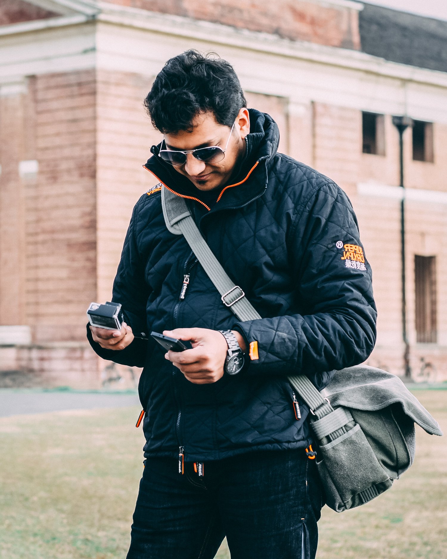 Azar Jindal looking down at his camera