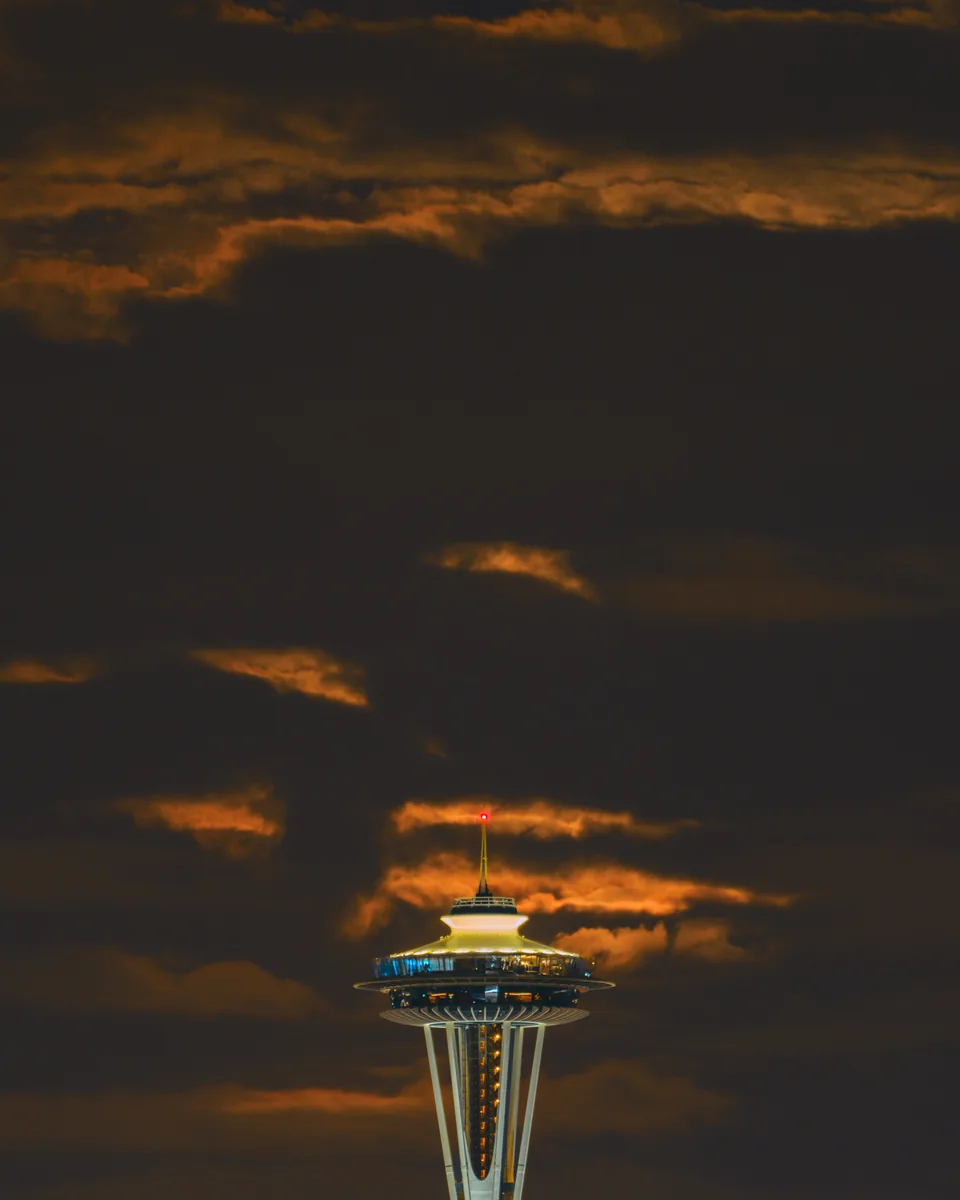 Moonrise behind clouds and the Space Needle, Seattle, Washington